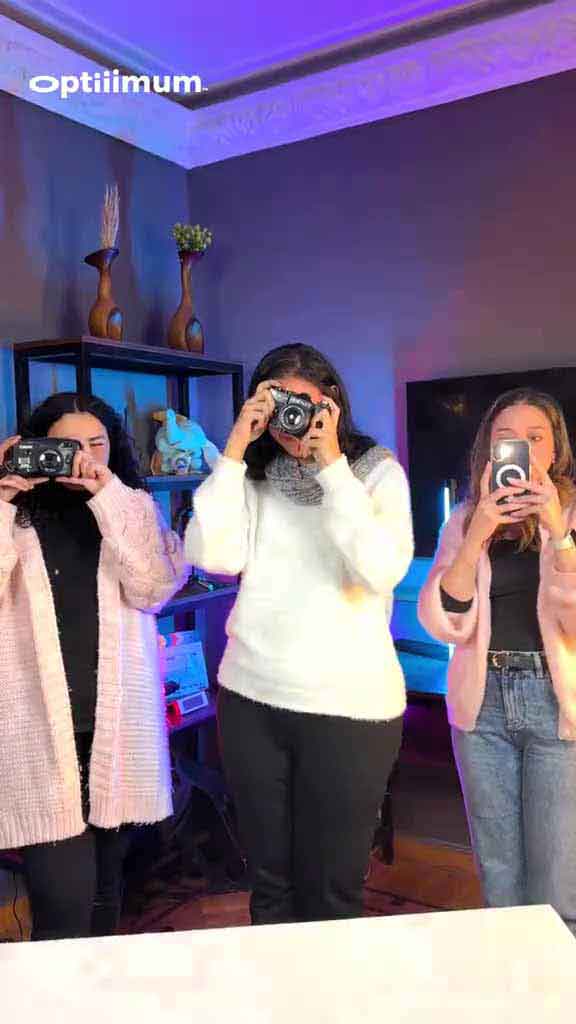 Optiiimum team members shooting with cameras in the studio